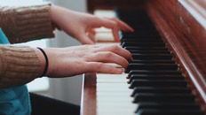 [photo: hands playing piano]